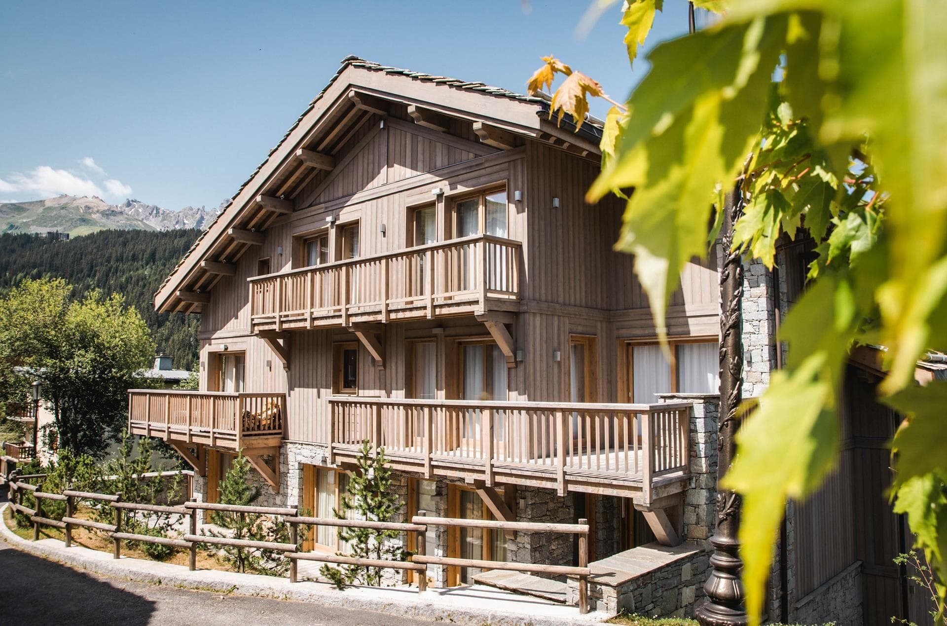 Chalet exterior with multiple private balconies and mountain views