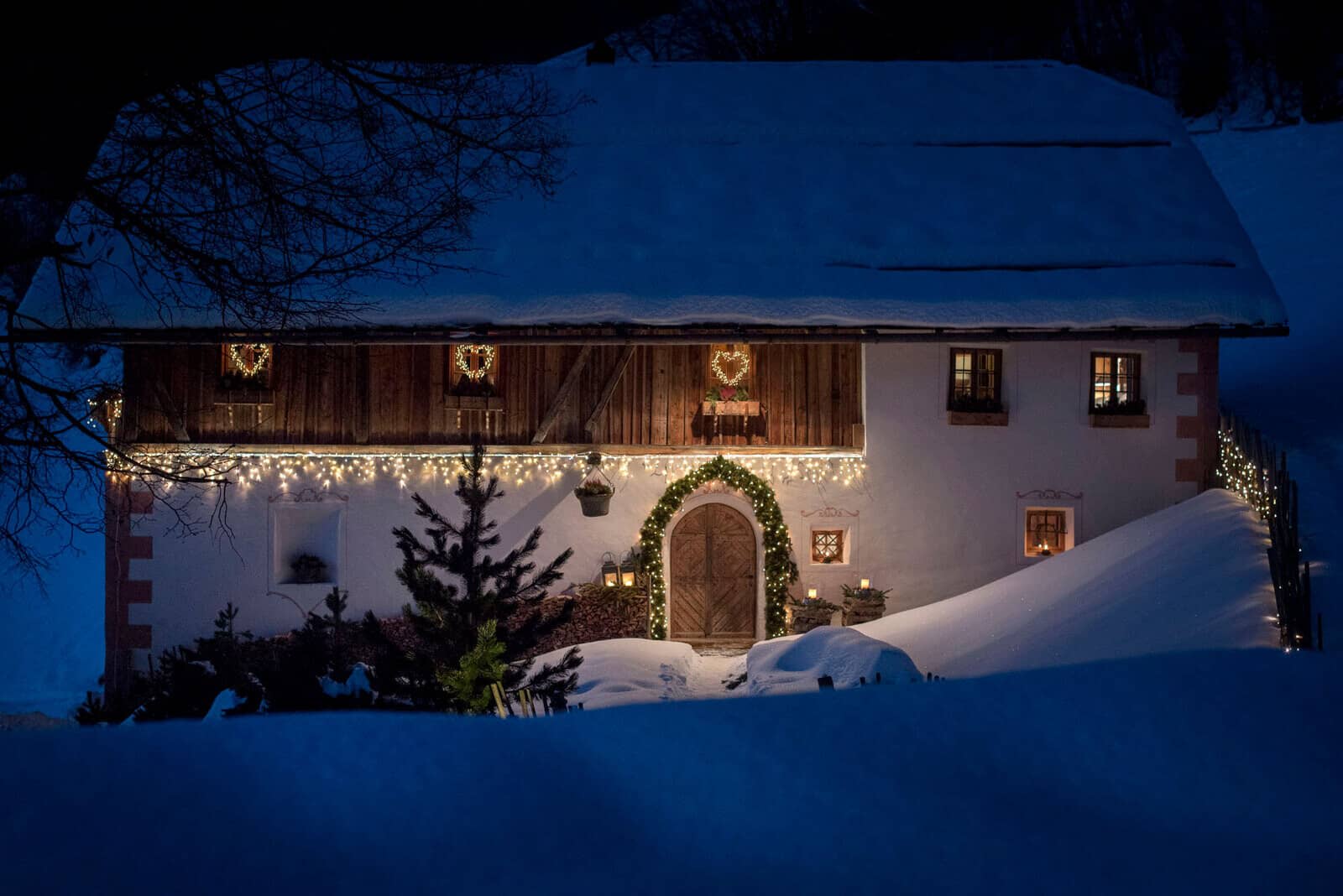 Chalet exterior with festive lighting and traditional carved arched doorway