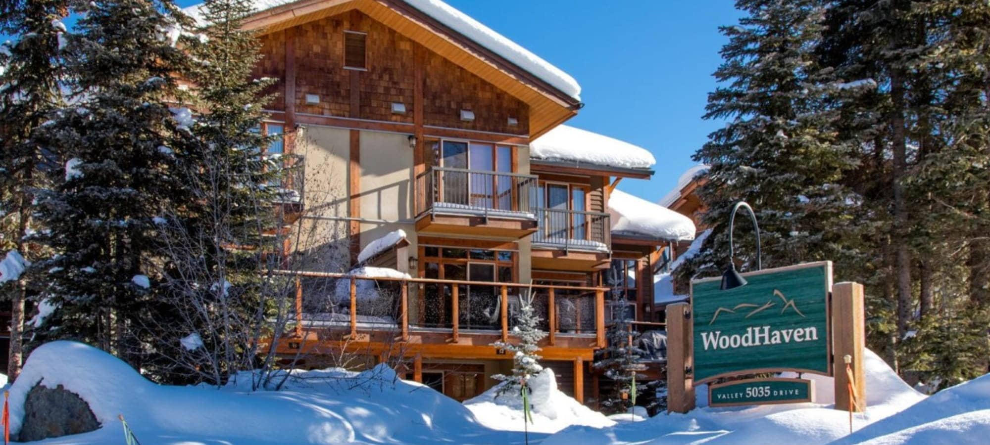 WoodHaven complex exterior with multi-level private balconies and snowy surroundings