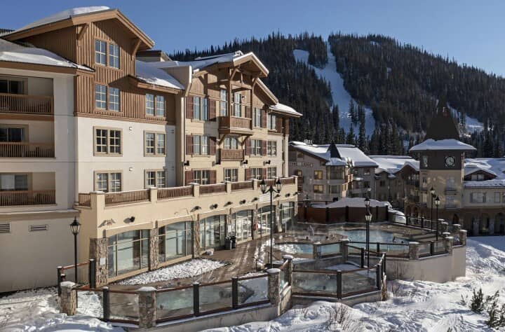 Ski-in/ski-out lodge exterior with heated outdoor pool and mountain views