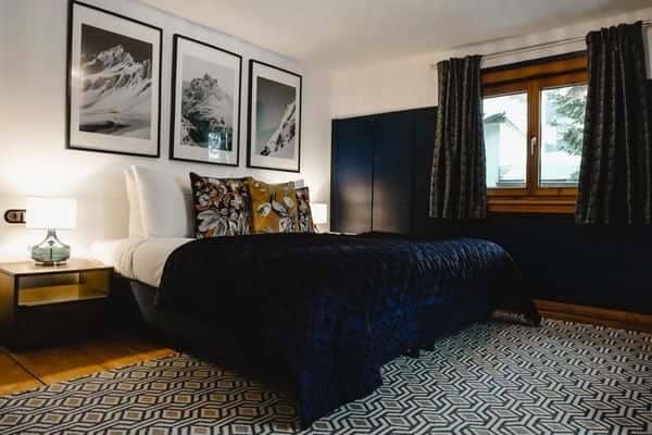 Guest bedroom with queen bed and built-in wardrobe storage