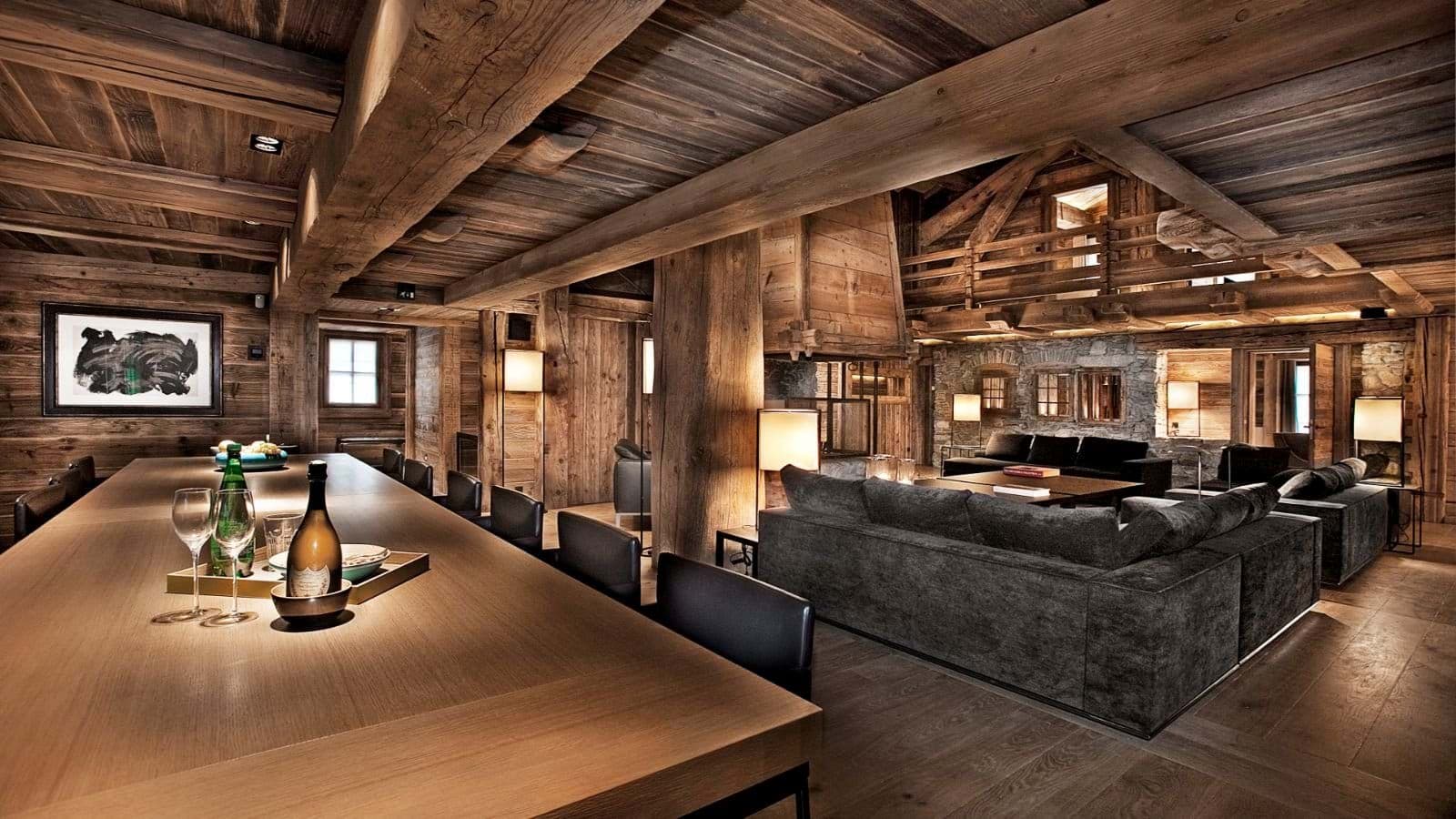 Open-plan living area with reclaimed wood beams and glass-enclosed fireplace