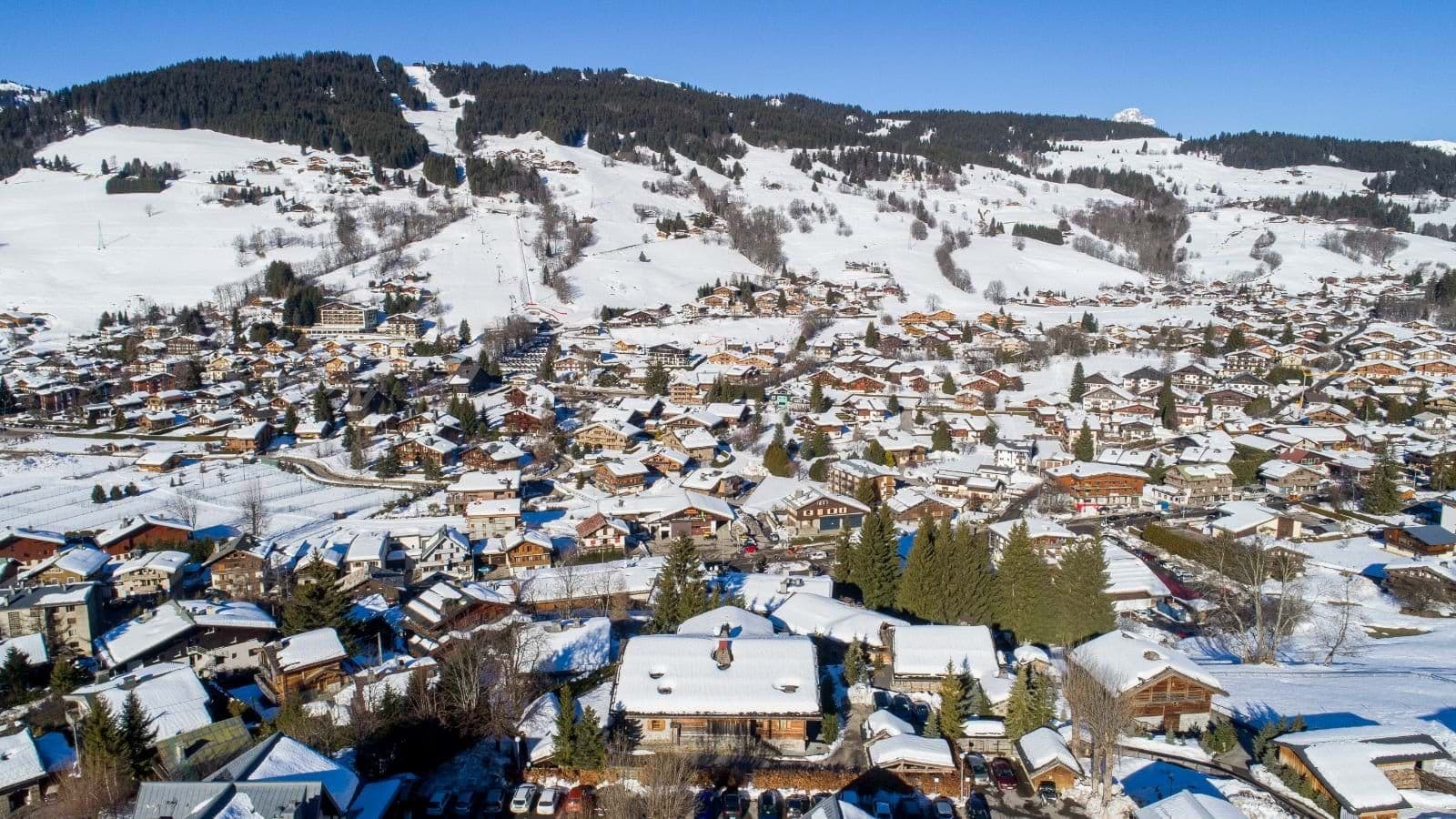 Aerial view of chalet village with ski run and lift access