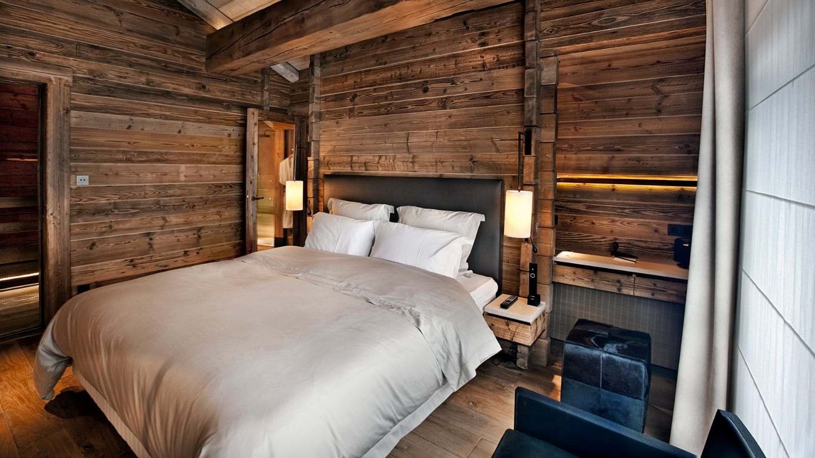 Bedroom with queen bed and ensuite bathroom entrance