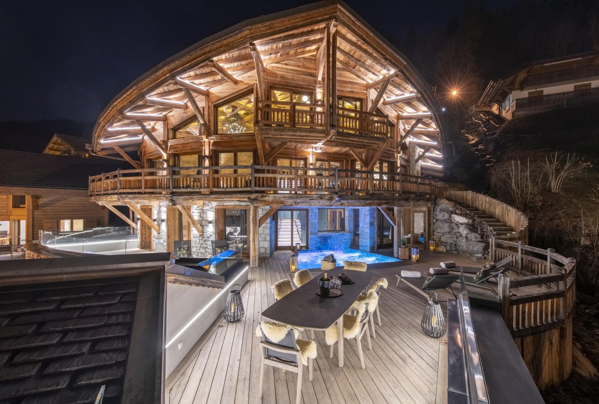 Chalet exterior with heated swim spa and alfresco dining for 8