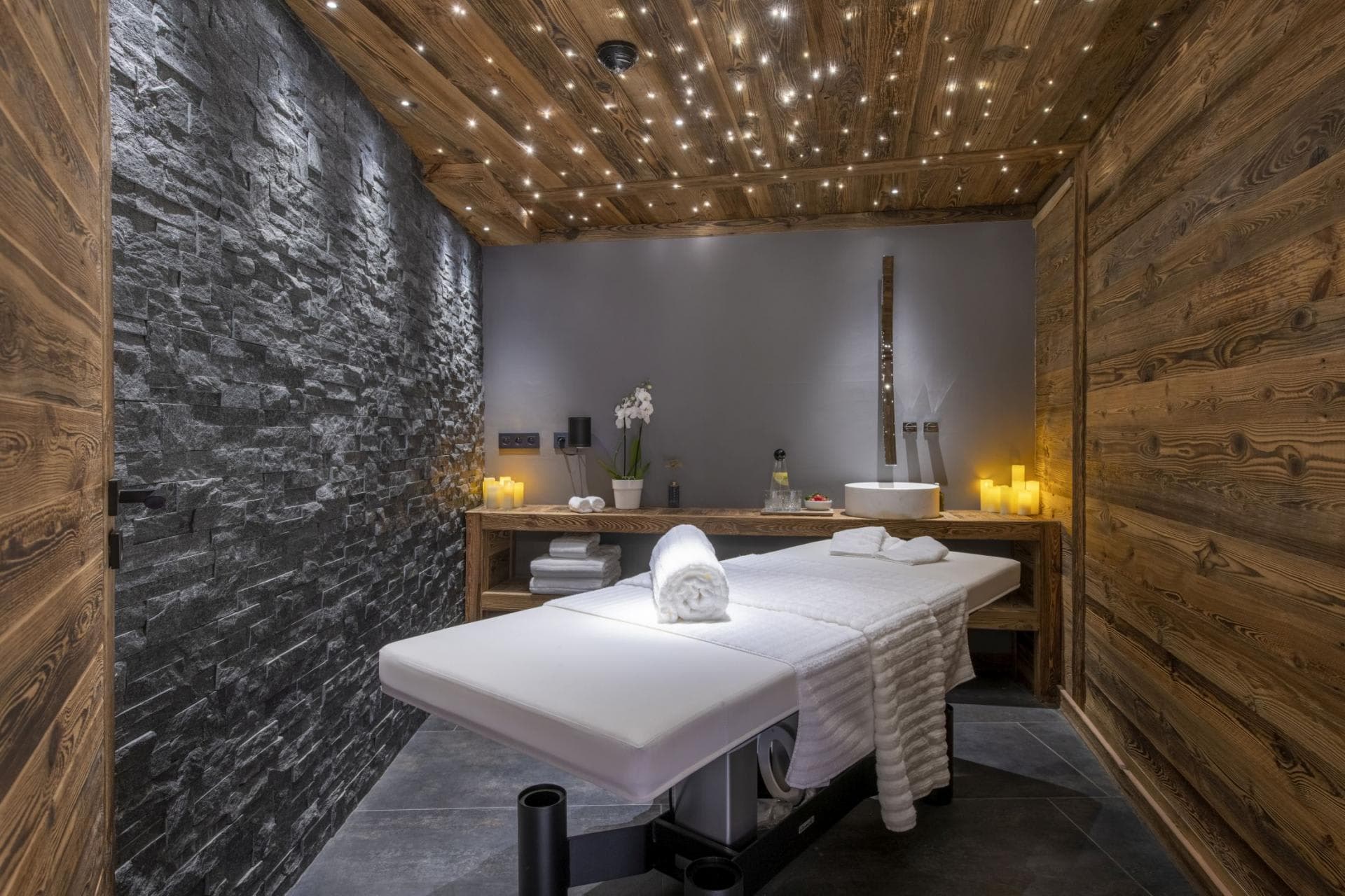 Private spa treatment room with massage table and fiber optic starlight ceiling