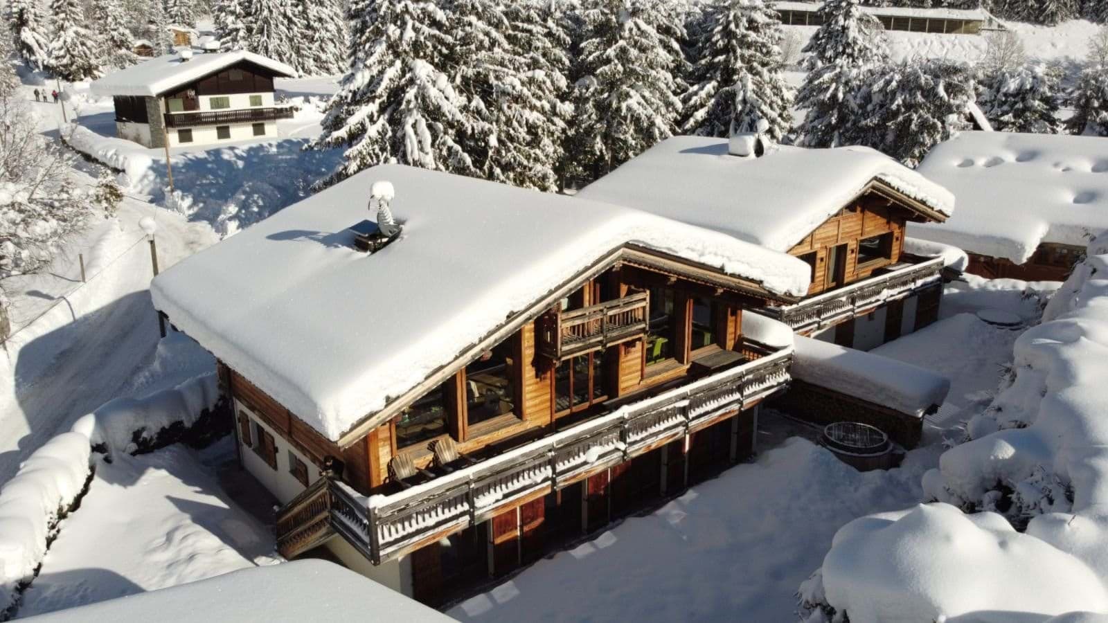 Chalet exterior with wrap-around balcony and private outdoor hot tub