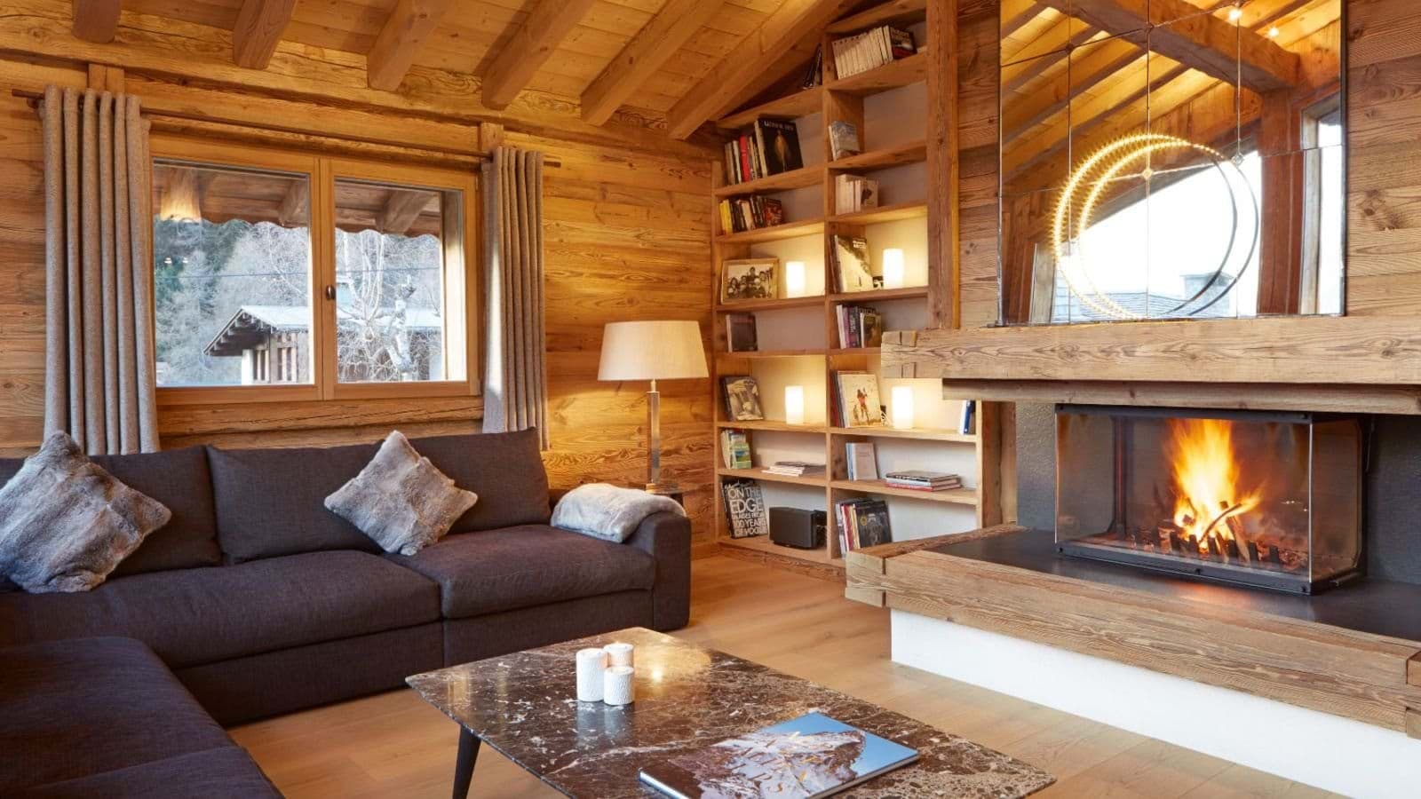 Living area with wood-burning fireplace and floor-to-ceiling built-in shelving