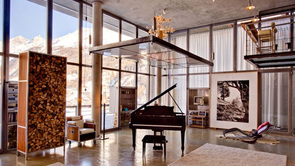 Great room with baby grand piano and floor-to-ceiling mountain views
