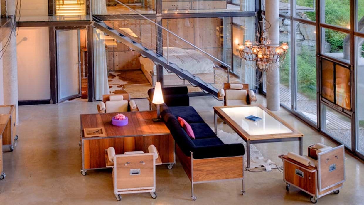 Open-plan living area with industrial steel staircase and polished concrete floors