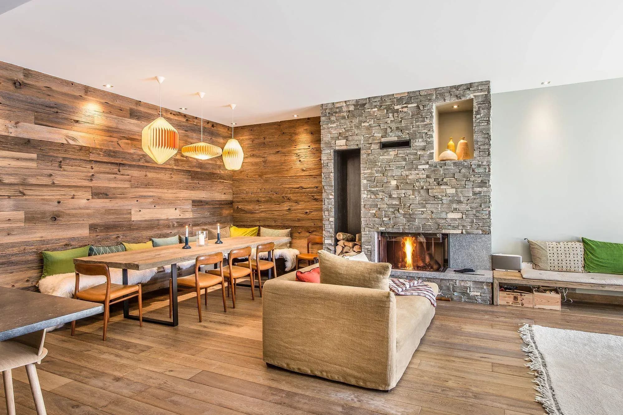 Living and dining area with stone fireplace and long wooden table