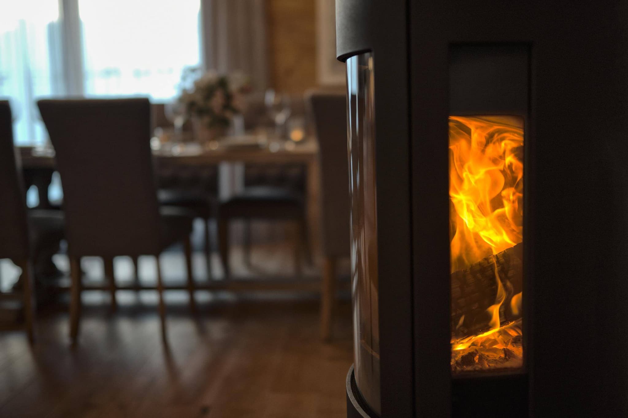 Wood-burning stove beside the open-plan lounge