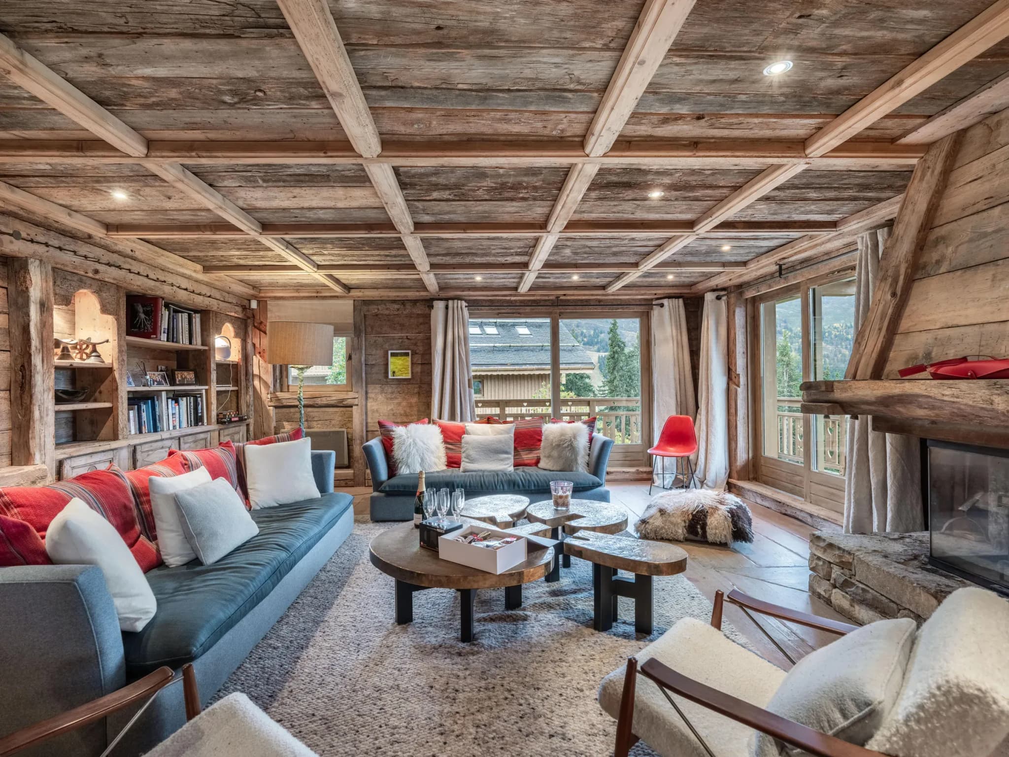 Lounge with two sofas, stone-topped coffee tables and open fireplace