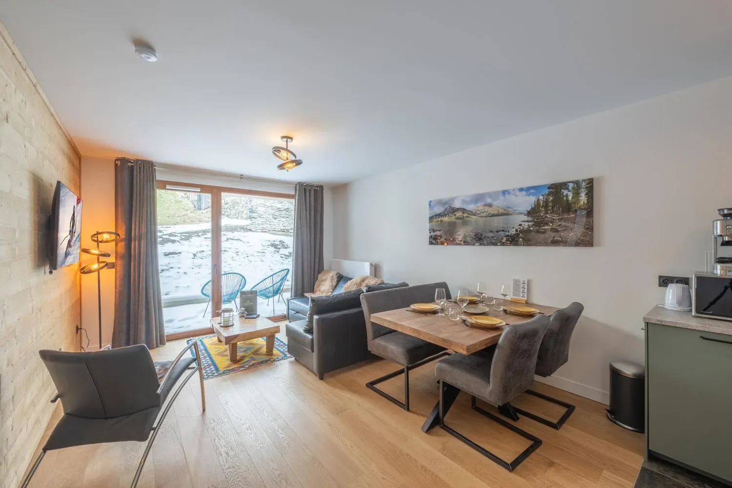 Living area with corner sofa, dining table and glass doors to terrace