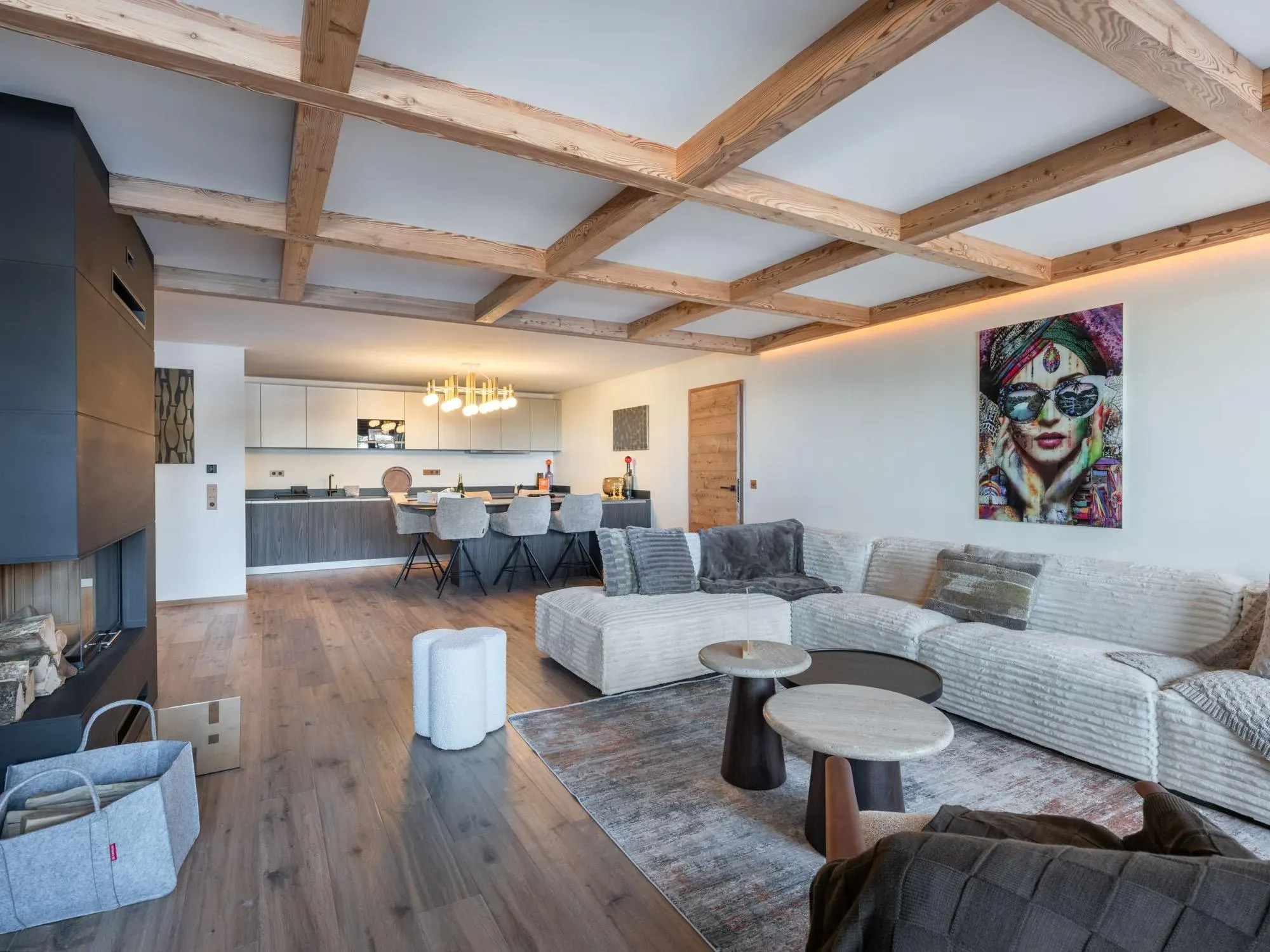 Open-plan living room with corner sofa, fireplace and exposed ceiling beams