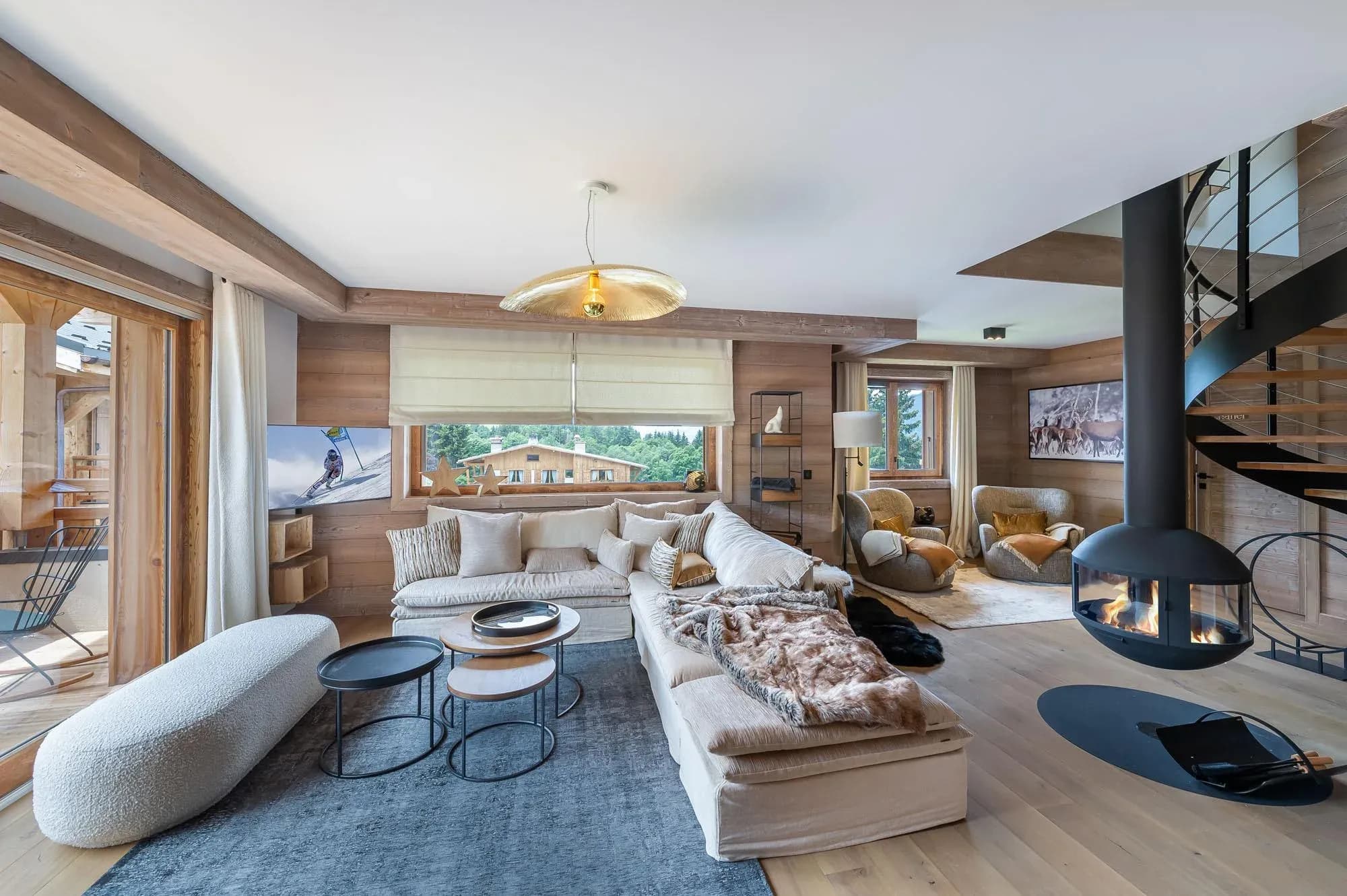 Living room with large corner sofa and hanging central fireplace
