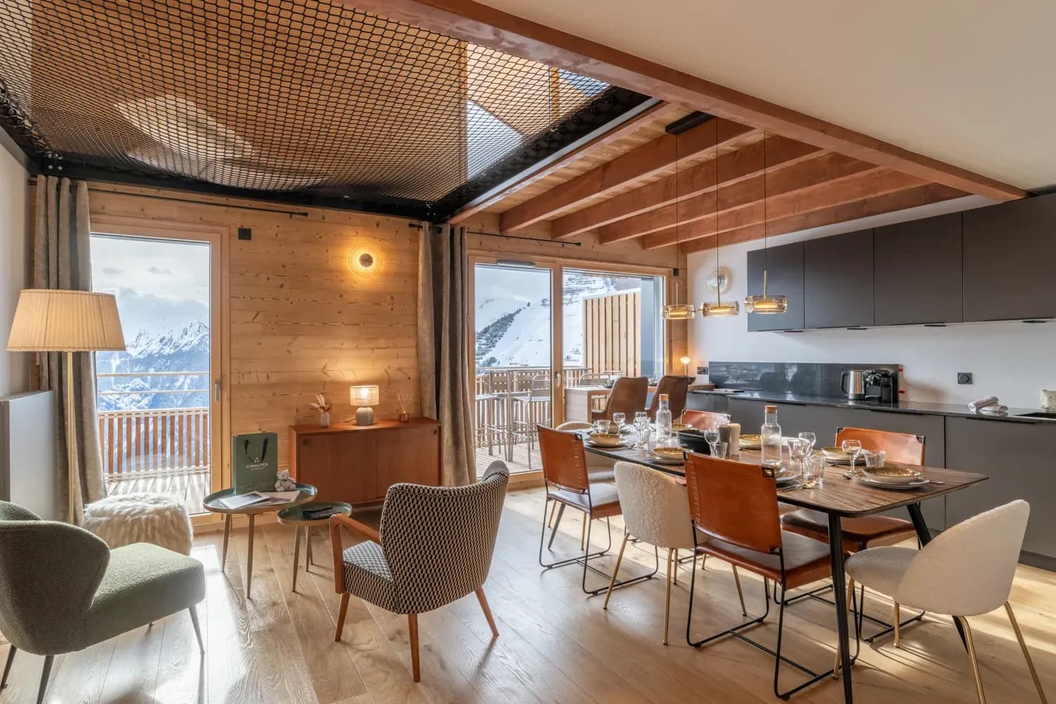 Open-plan dining area and lounge with eight-seat table and mountain views