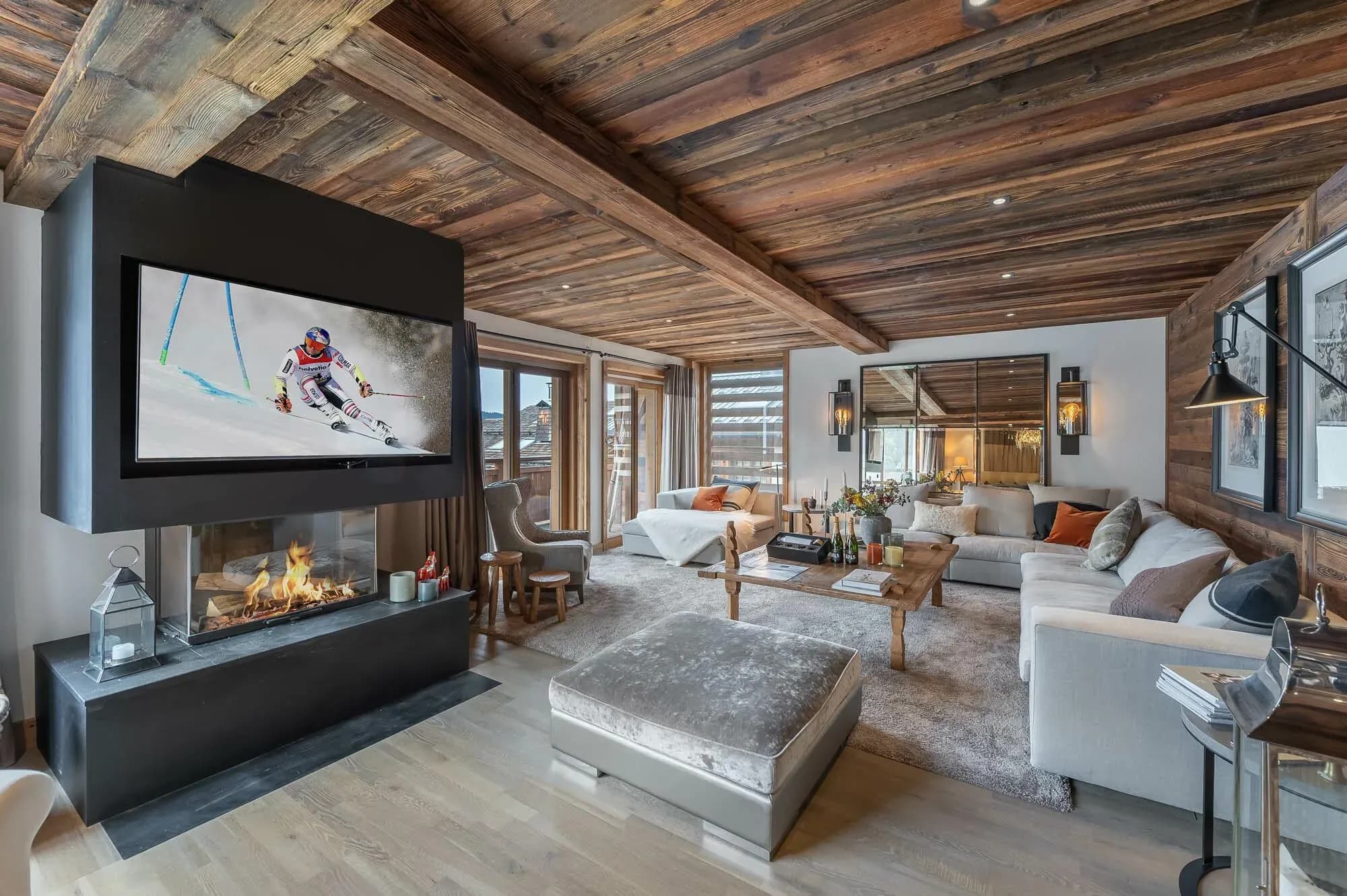 Living room with corner sofa, central fireplace and wall-mounted TV