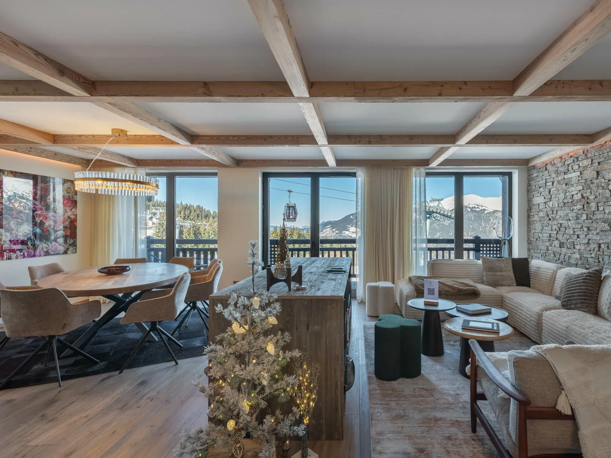 Open-plan living and dining area with beamed ceiling and mountain views