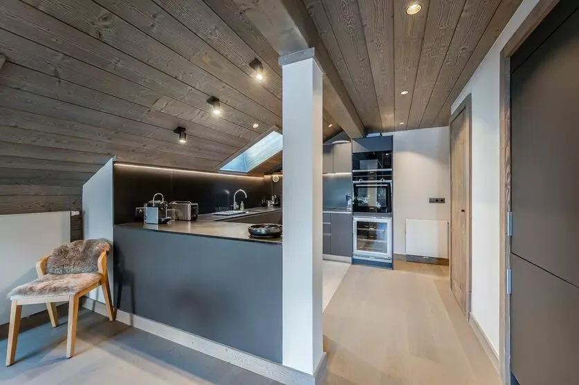 Open kitchen with island seating and built-in ovens
