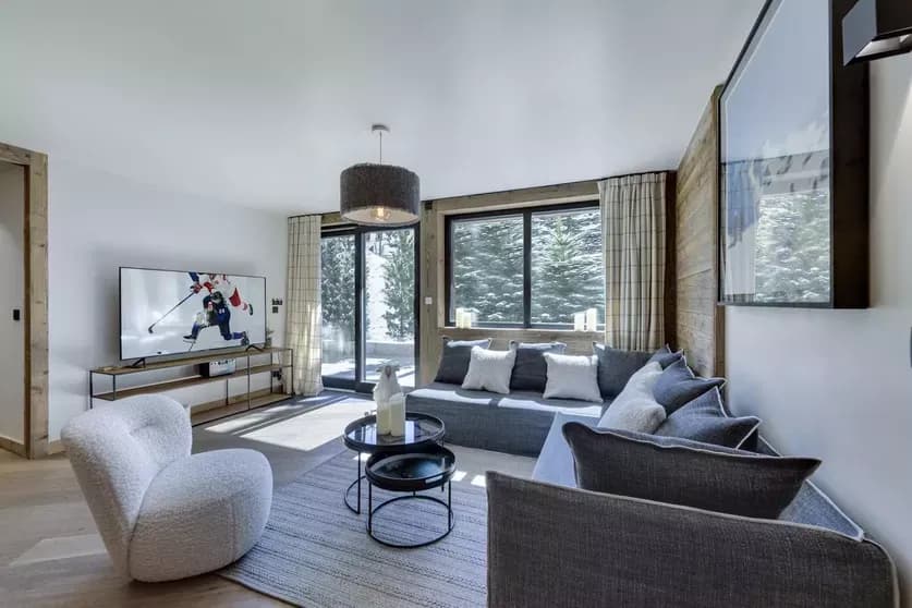 Living room with sectional seating, television and terrace doors