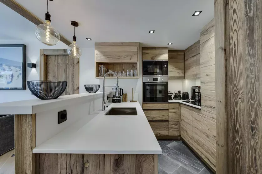 Open kitchen with fitted appliances and breakfast counter