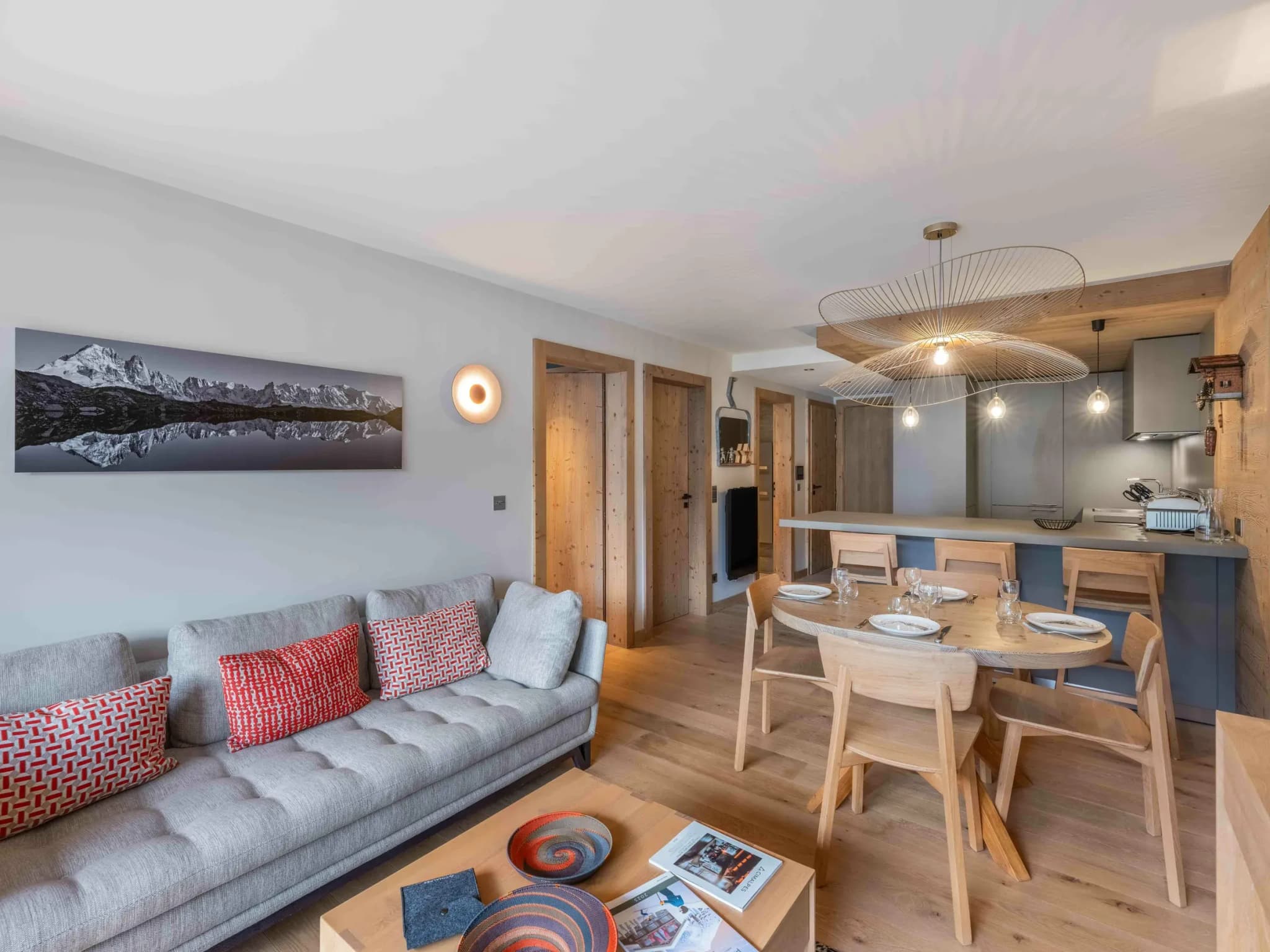 Living area with grey sofa, coffee table and open view to dining table