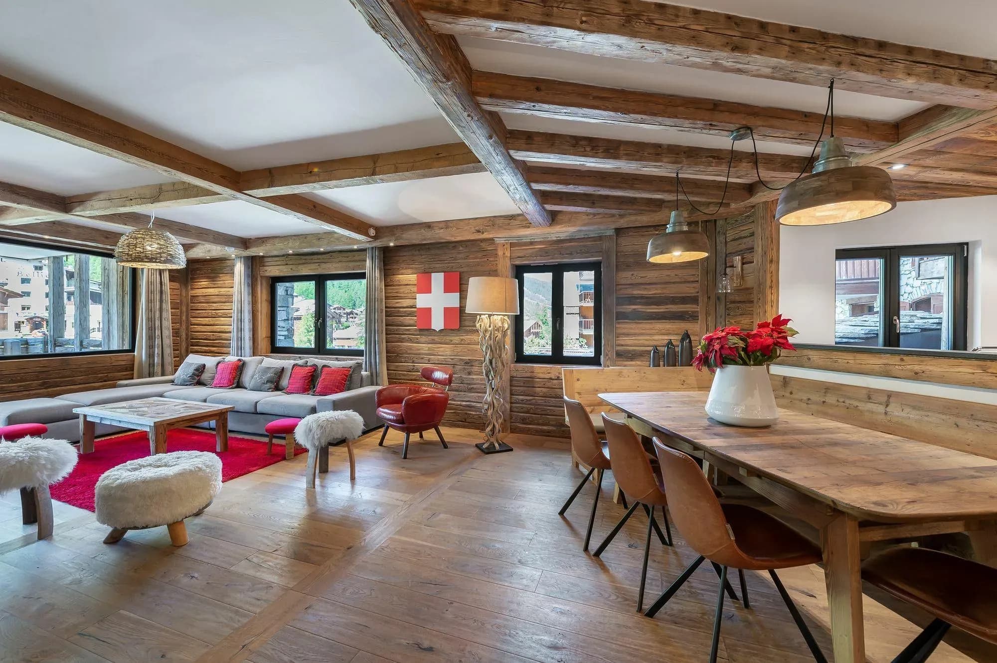 Open-plan lounge and dining area with corner sofa and long table for ten