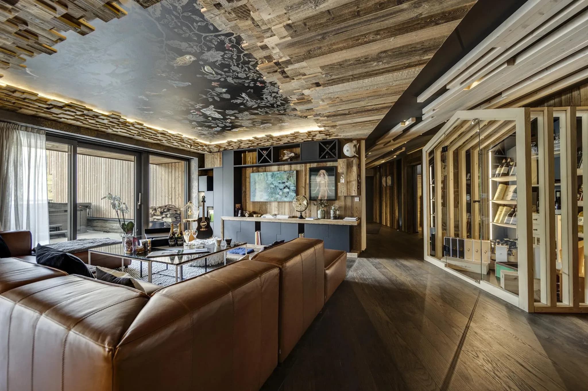Living room with leather corner sofa, patterned ceiling and glass wine cabinet