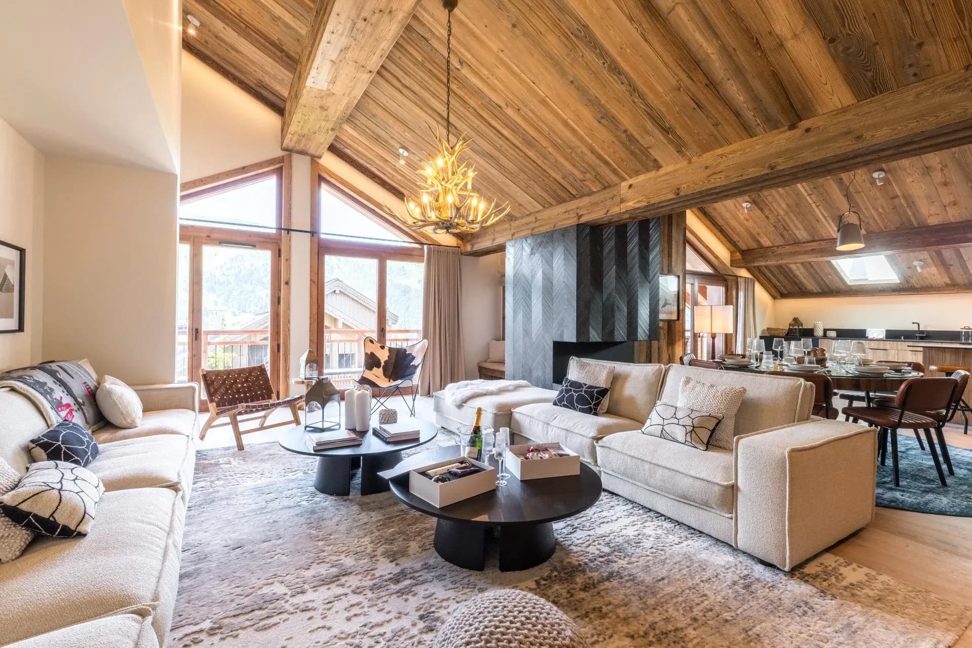Living room with two sofas, round coffee tables and antler chandelier