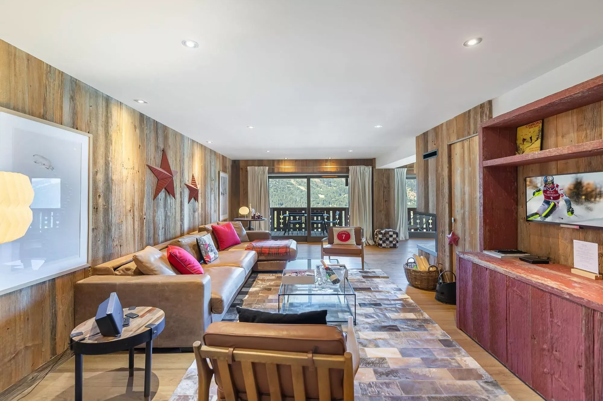 Living room opening onto a balcony with mountain views