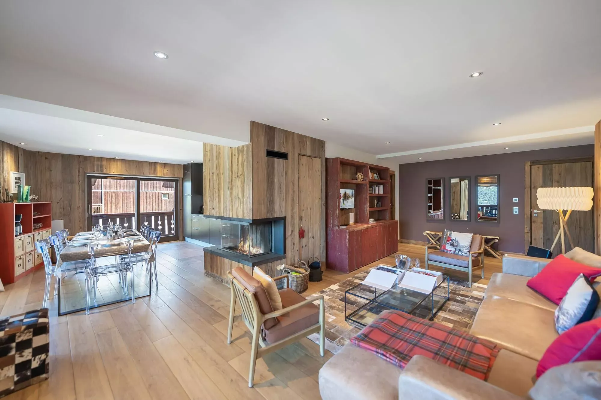 Dining area beside the open kitchen and fireplace
