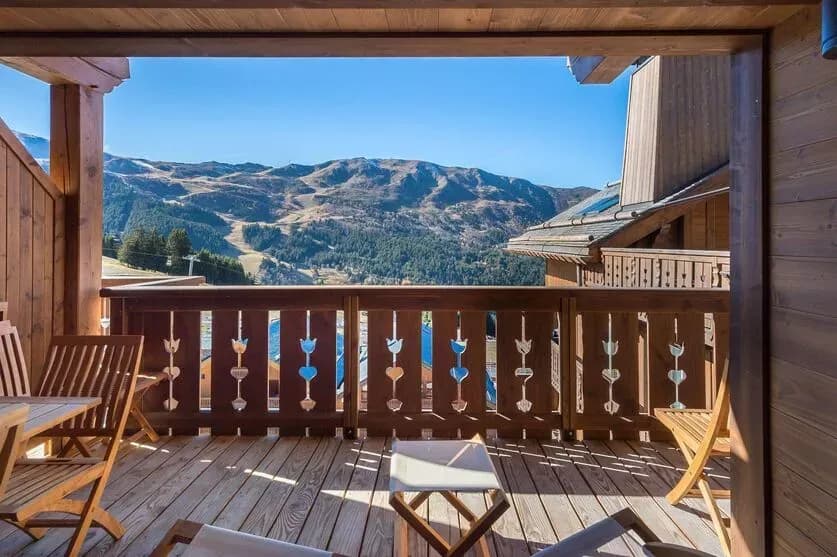 Covered balcony with outdoor seating and mountain views