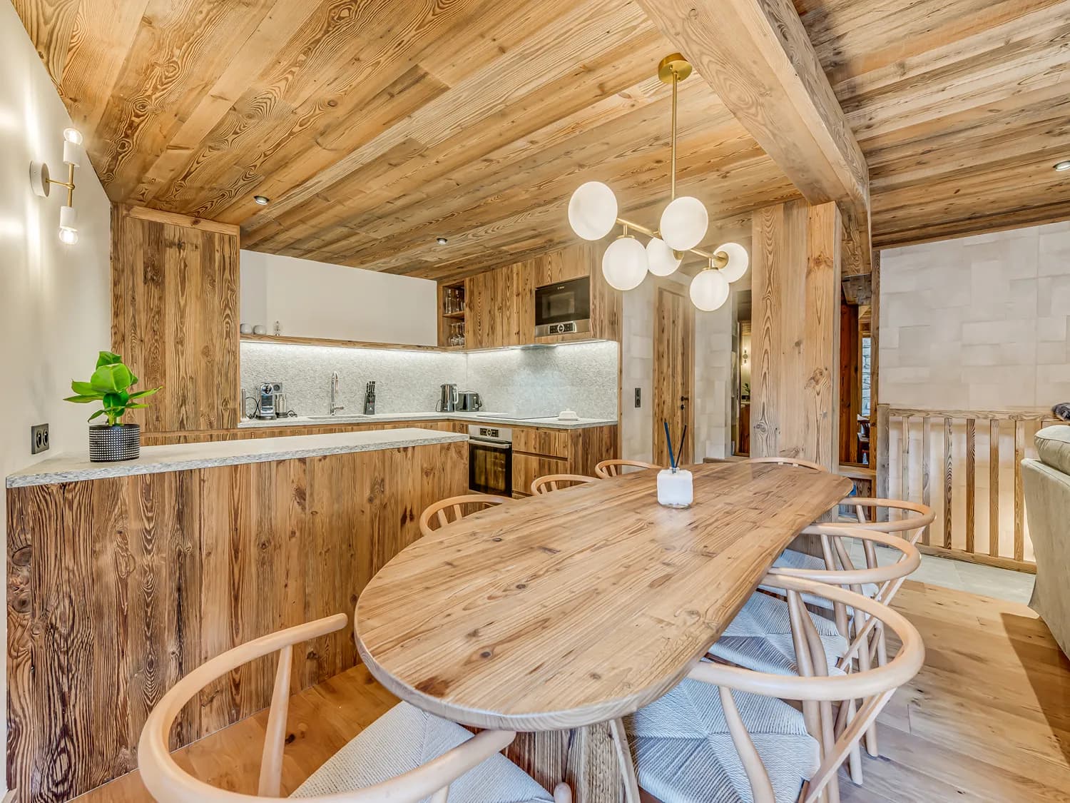Fully equipped kitchen beside a timber dining table