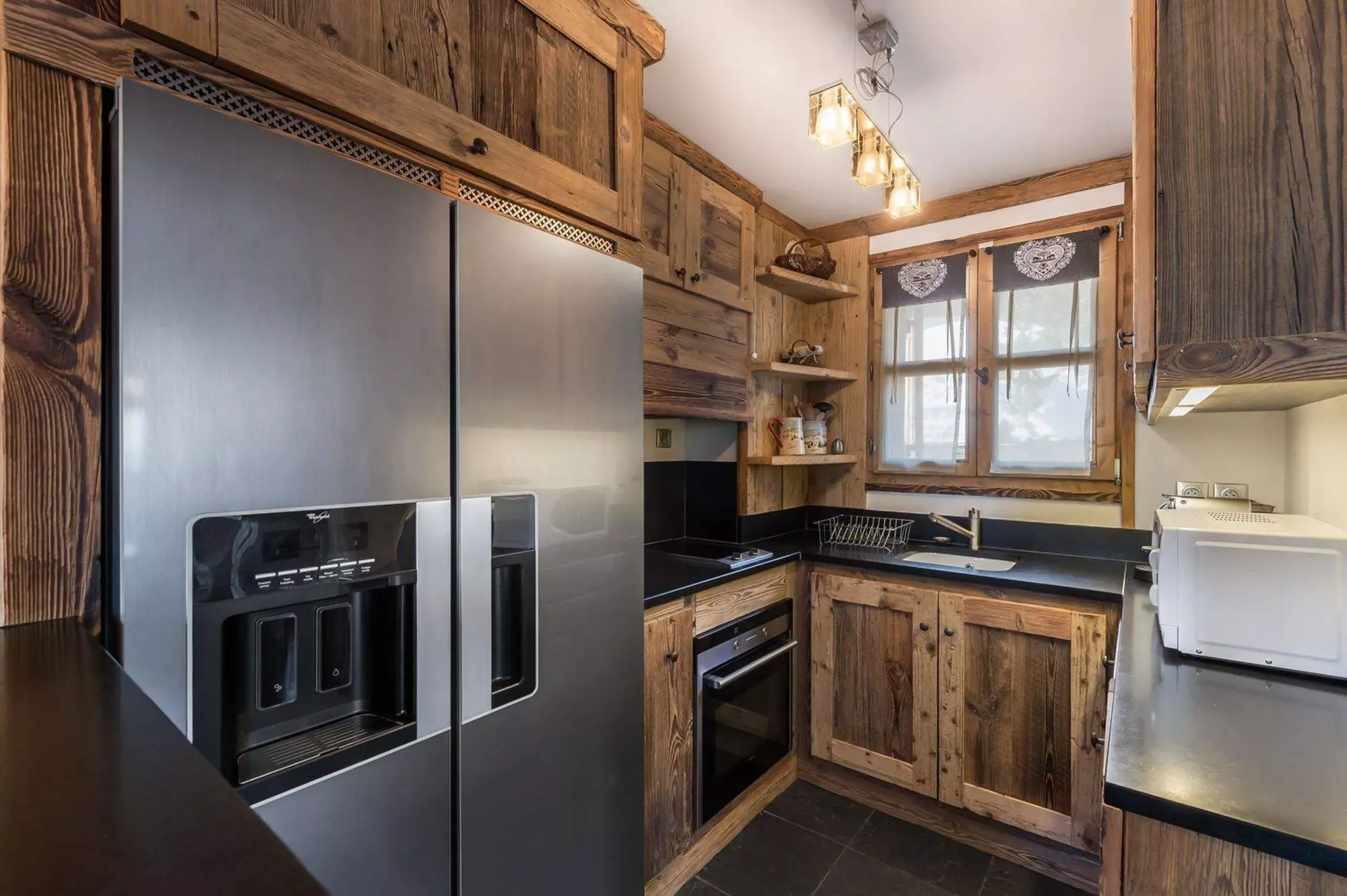 Open kitchen with timber cabinetry and integrated appliances