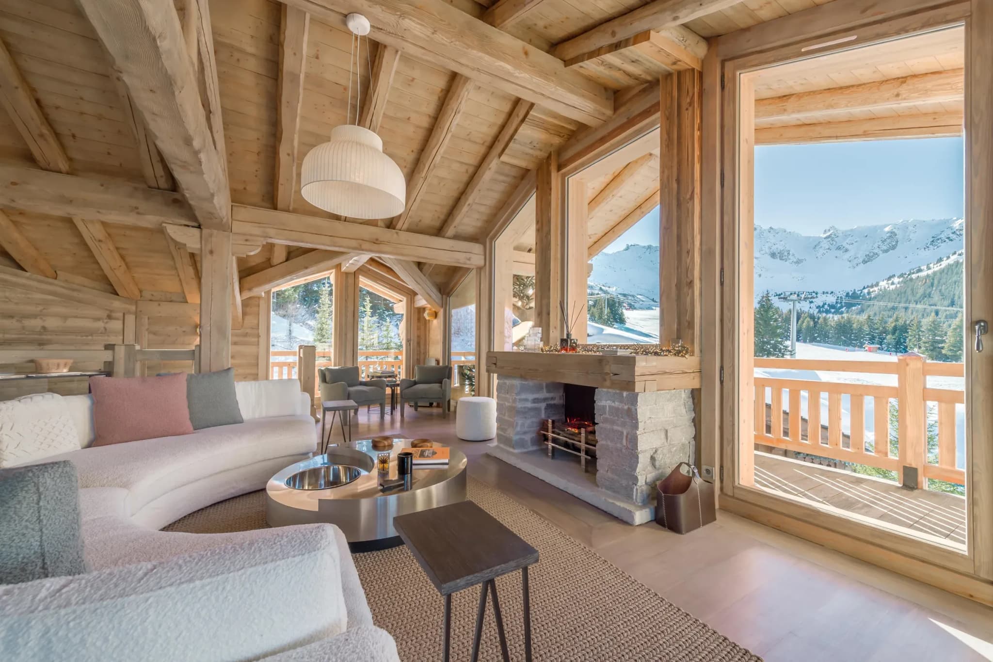 Living room with wood-beam ceilings, fireplace, and panoramic mountain views