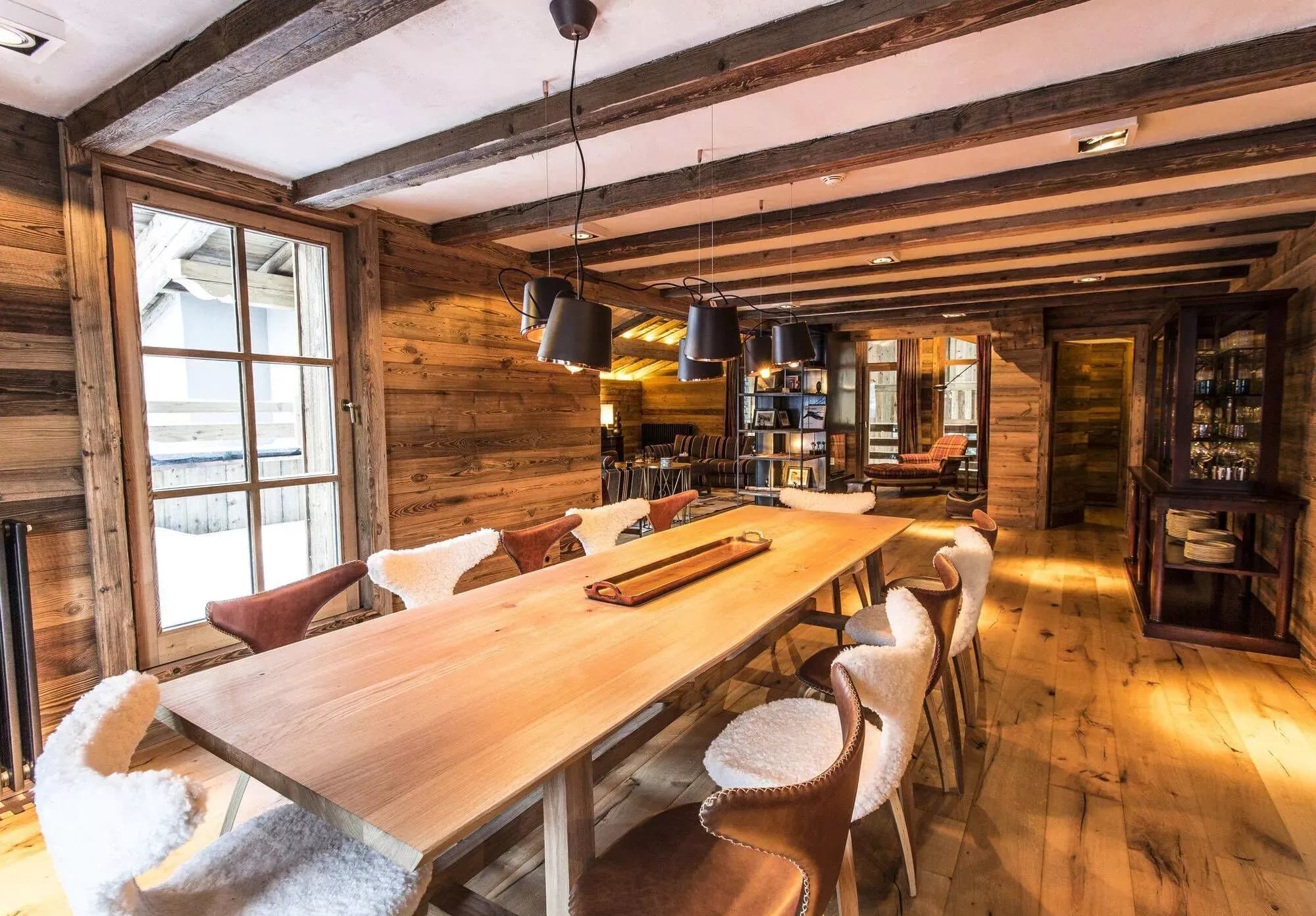 Dining room with a long timber table beside the open kitchen