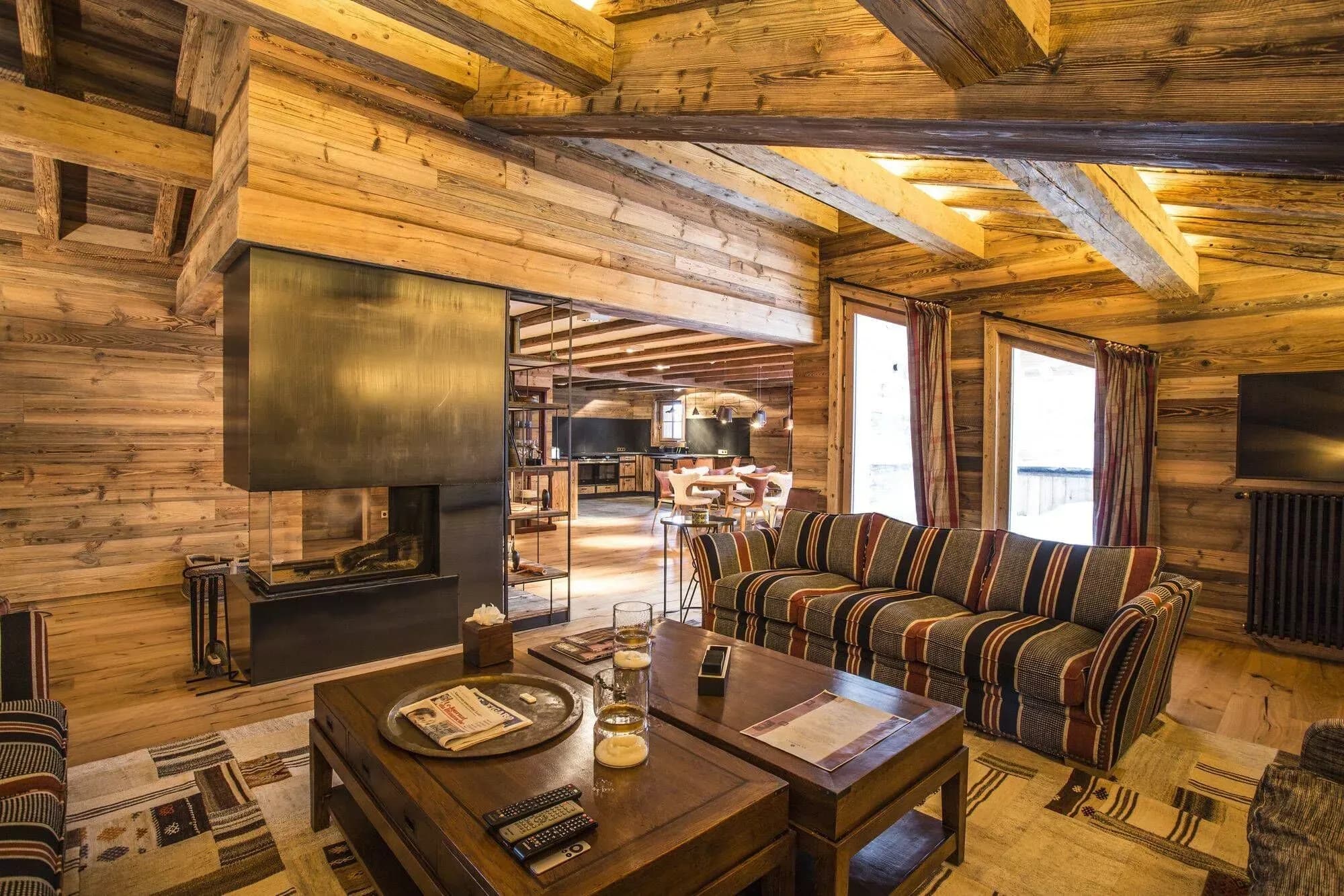 Living room with a black fireplace and the adjoining dining area beyond