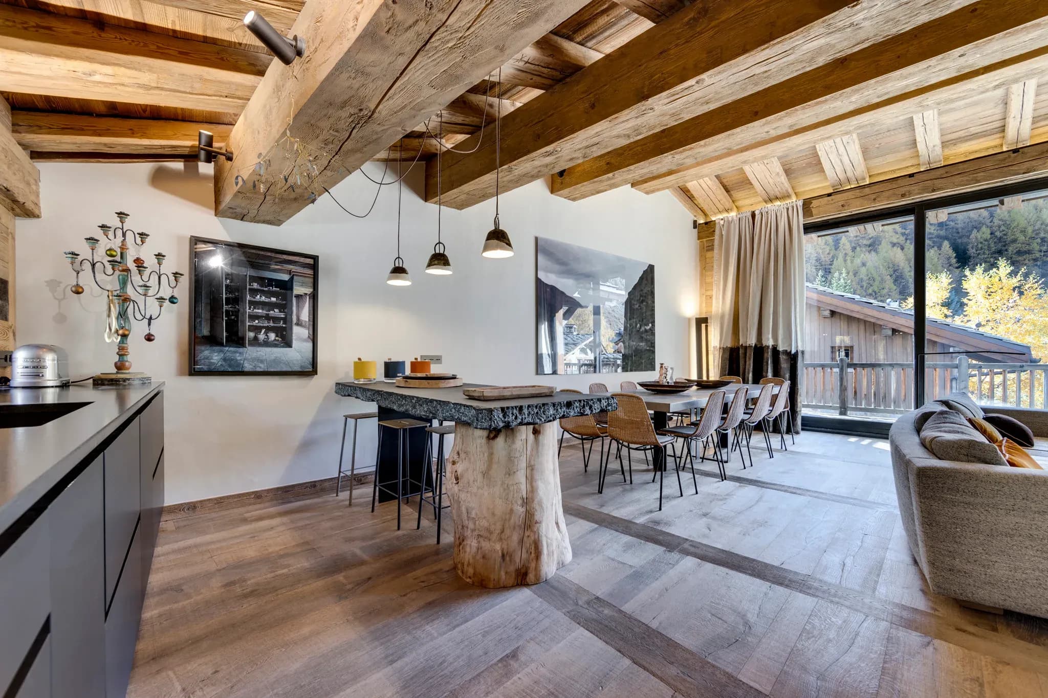Open-plan dining and kitchen with exposed beams; seats 8 at live-edge table