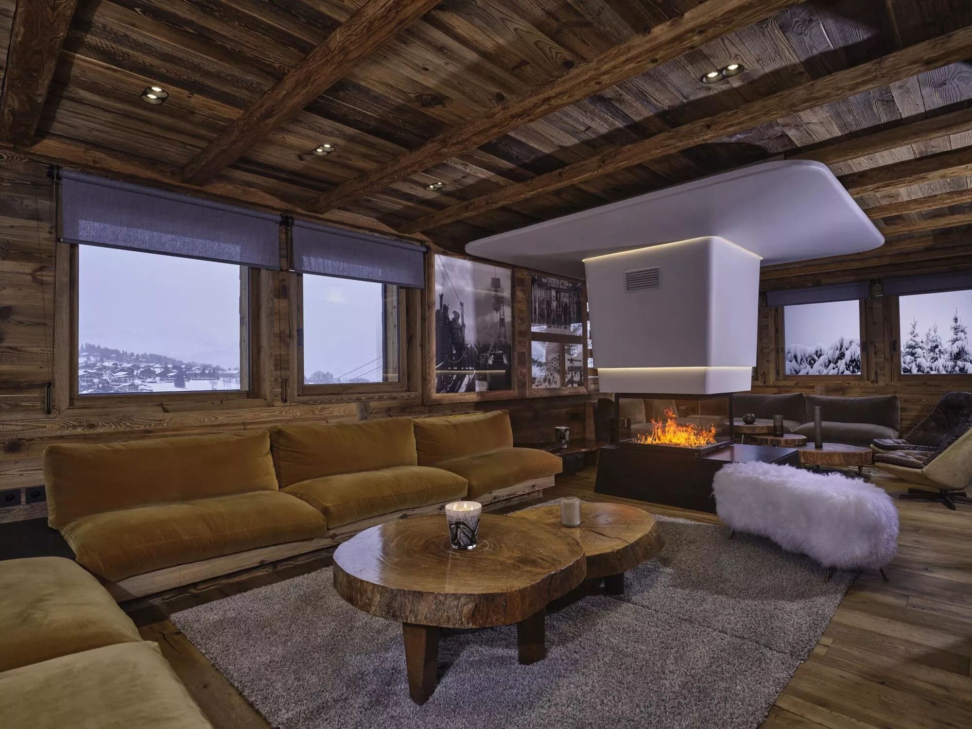 Main lounge with wraparound seating around the central fireplace