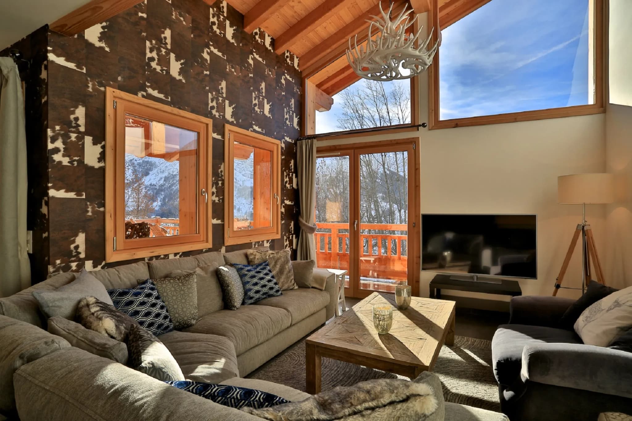 Living room with mountain views through tall windows