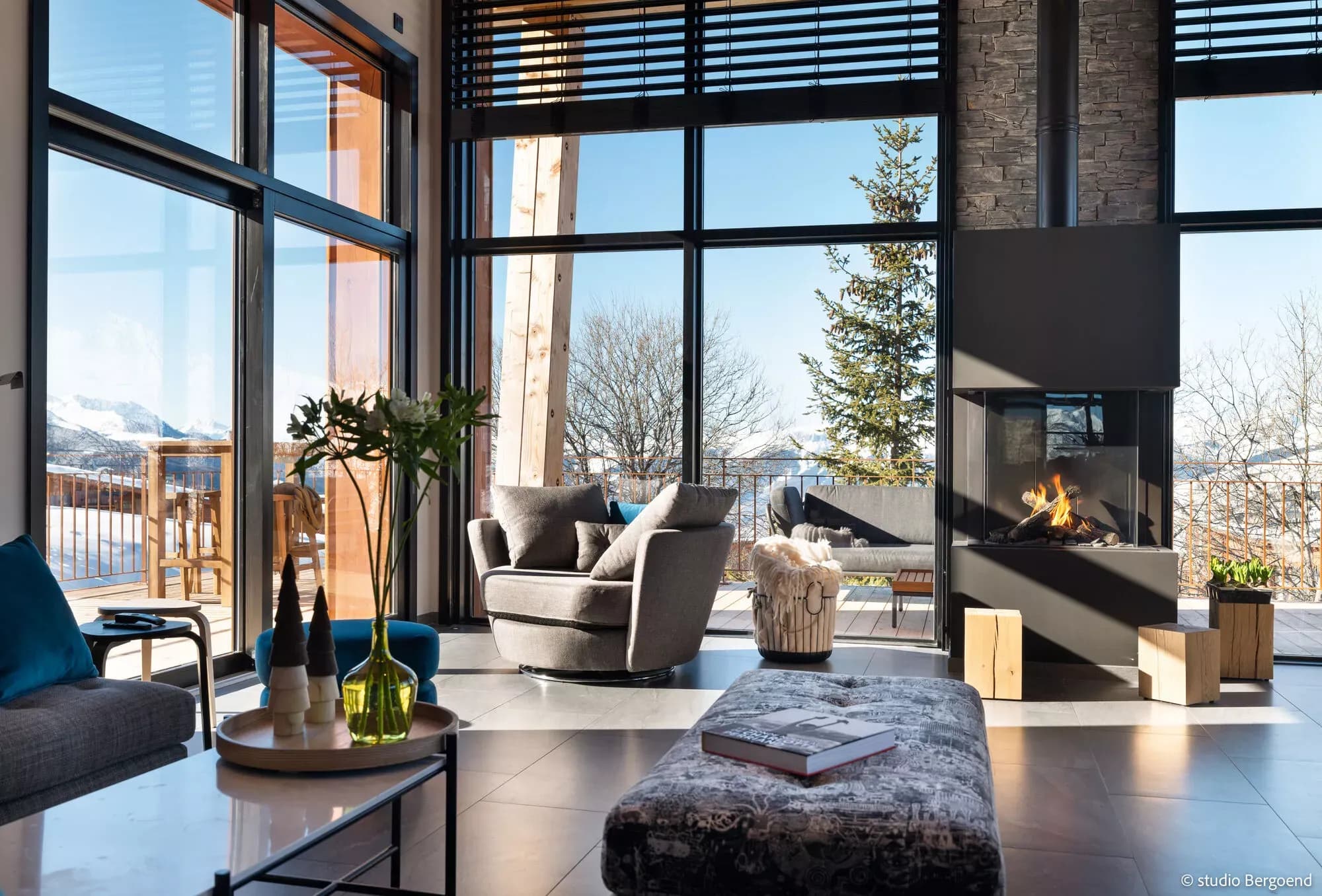 Living room with gas fireplace, balcony access and mountain views