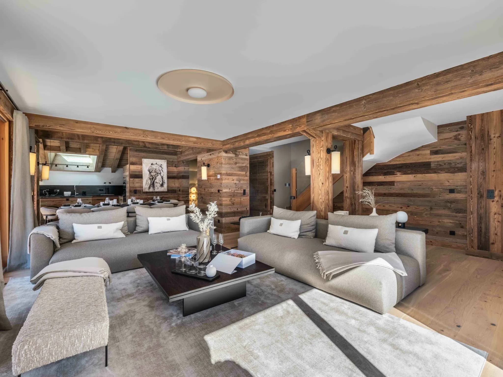 Living room with two grey sofas, coffee table and open dining area beyond