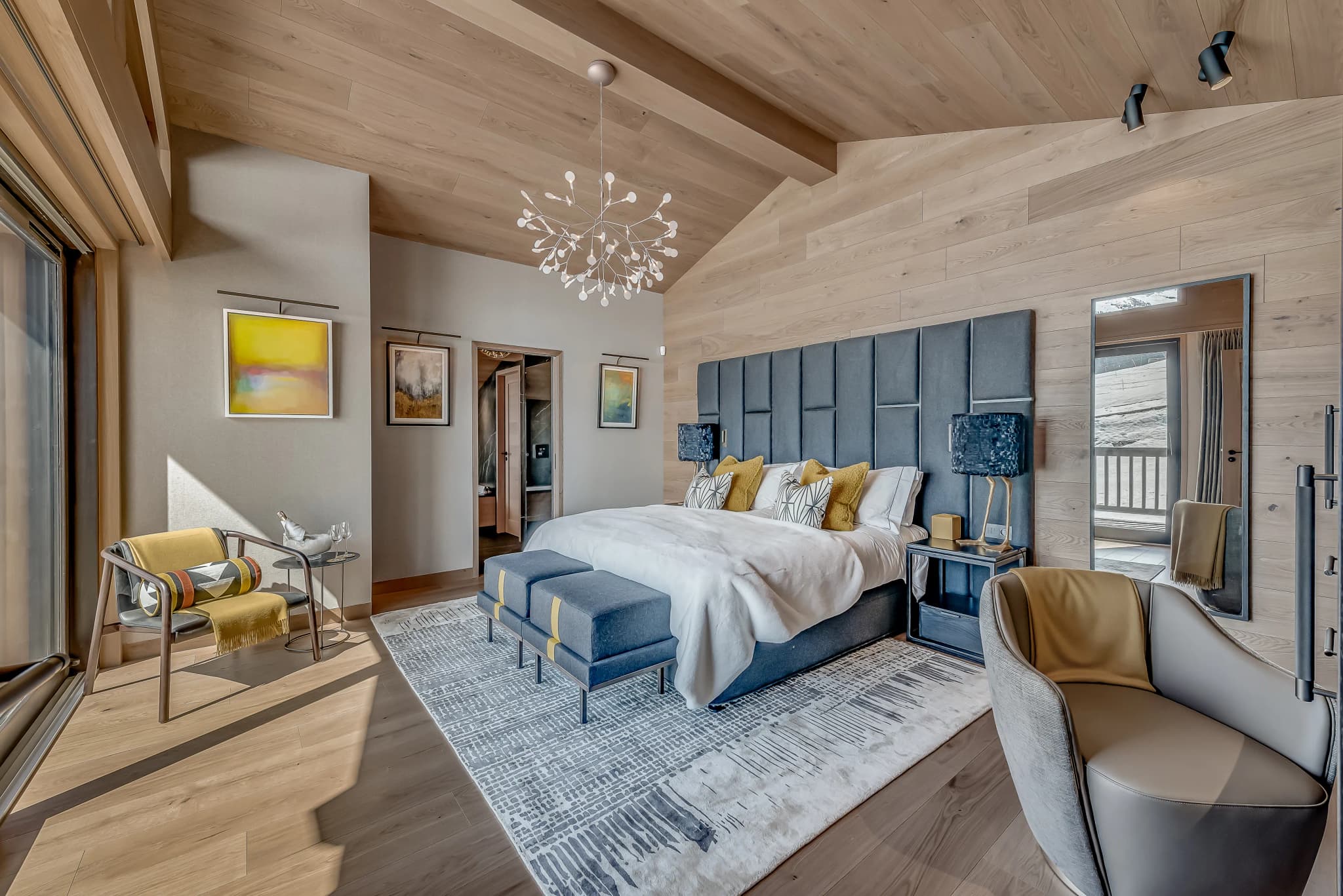 Primary bedroom with high ceilings, seating and terrace doors