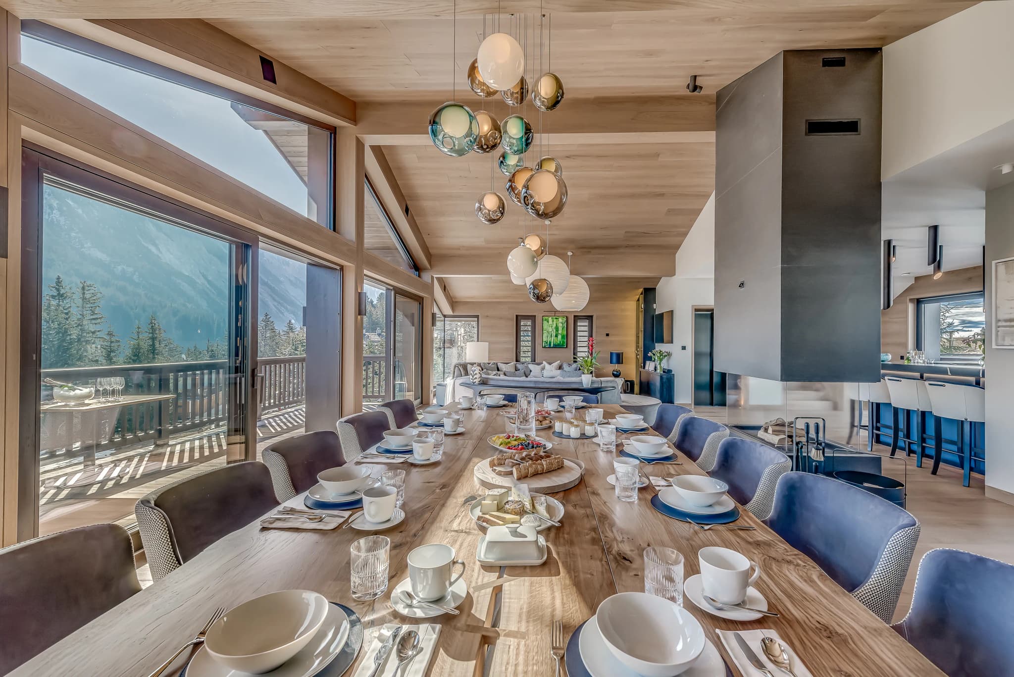 Dining table set beside mountain-facing windows