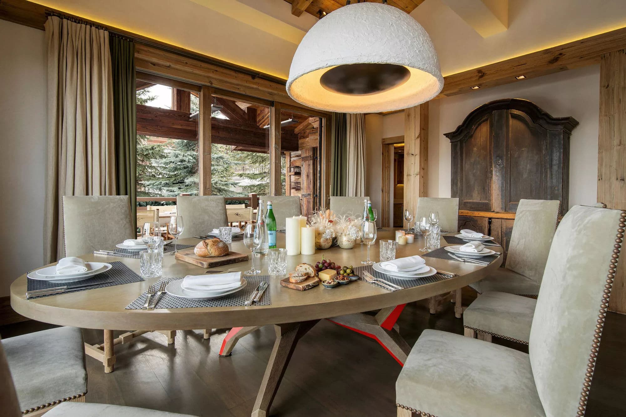 Dining table beside full-height windows