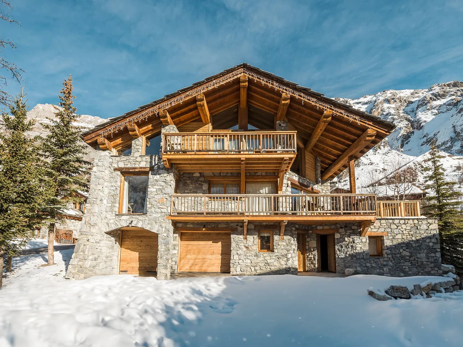 Snow-covered timber chalet with south-facing balconies