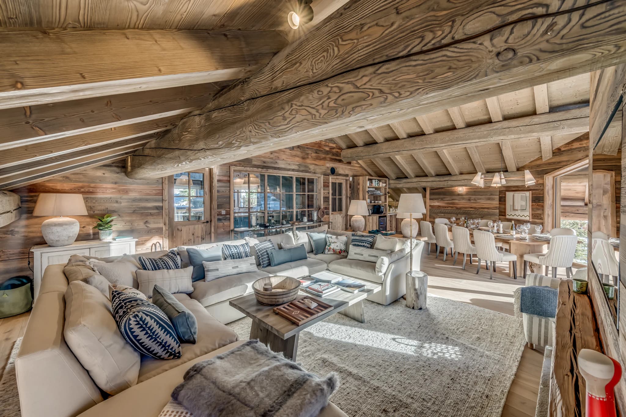 Lounge and dining area beneath exposed timber beams