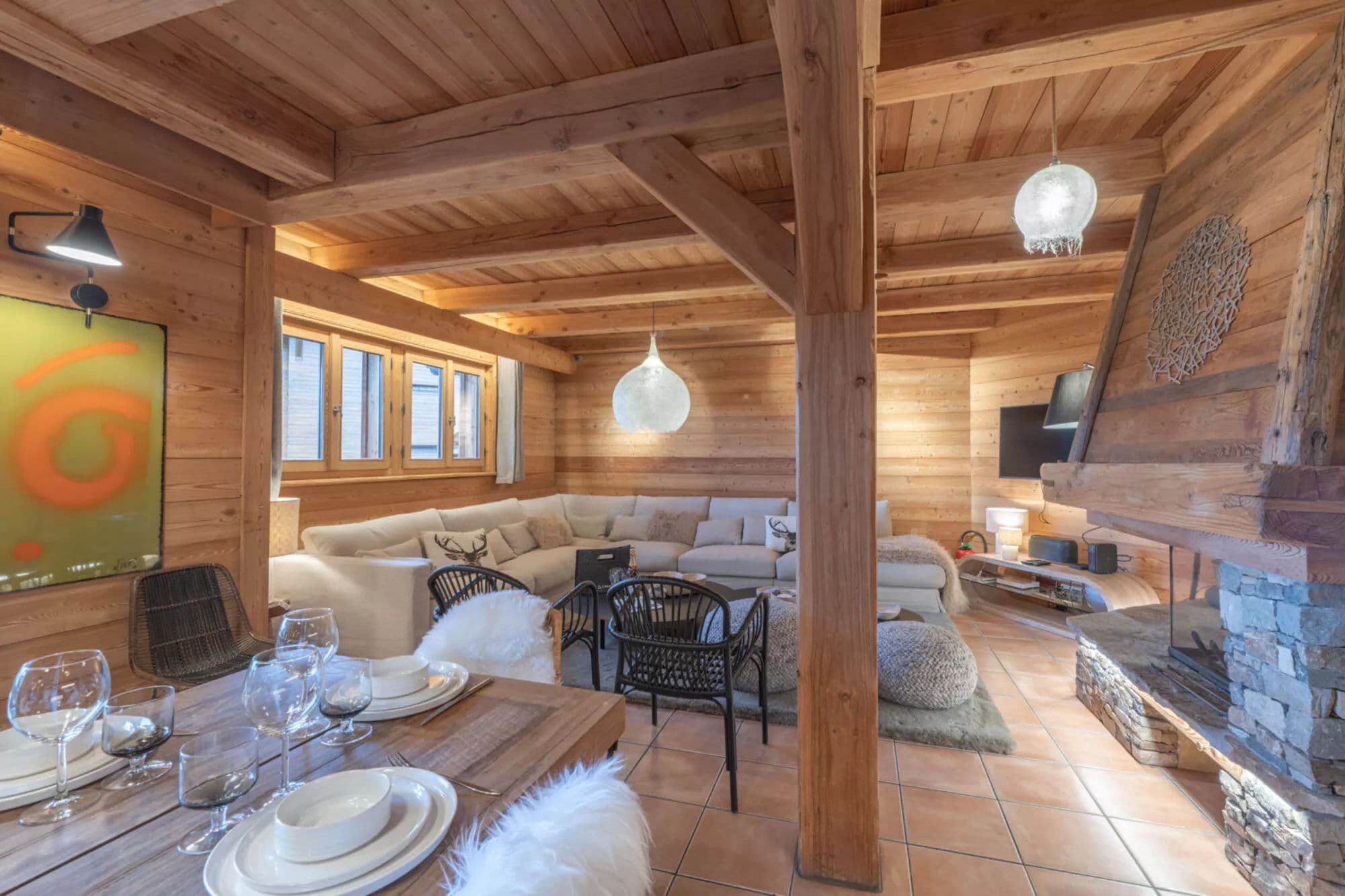 Dining table beside the open-plan lounge and fireplace