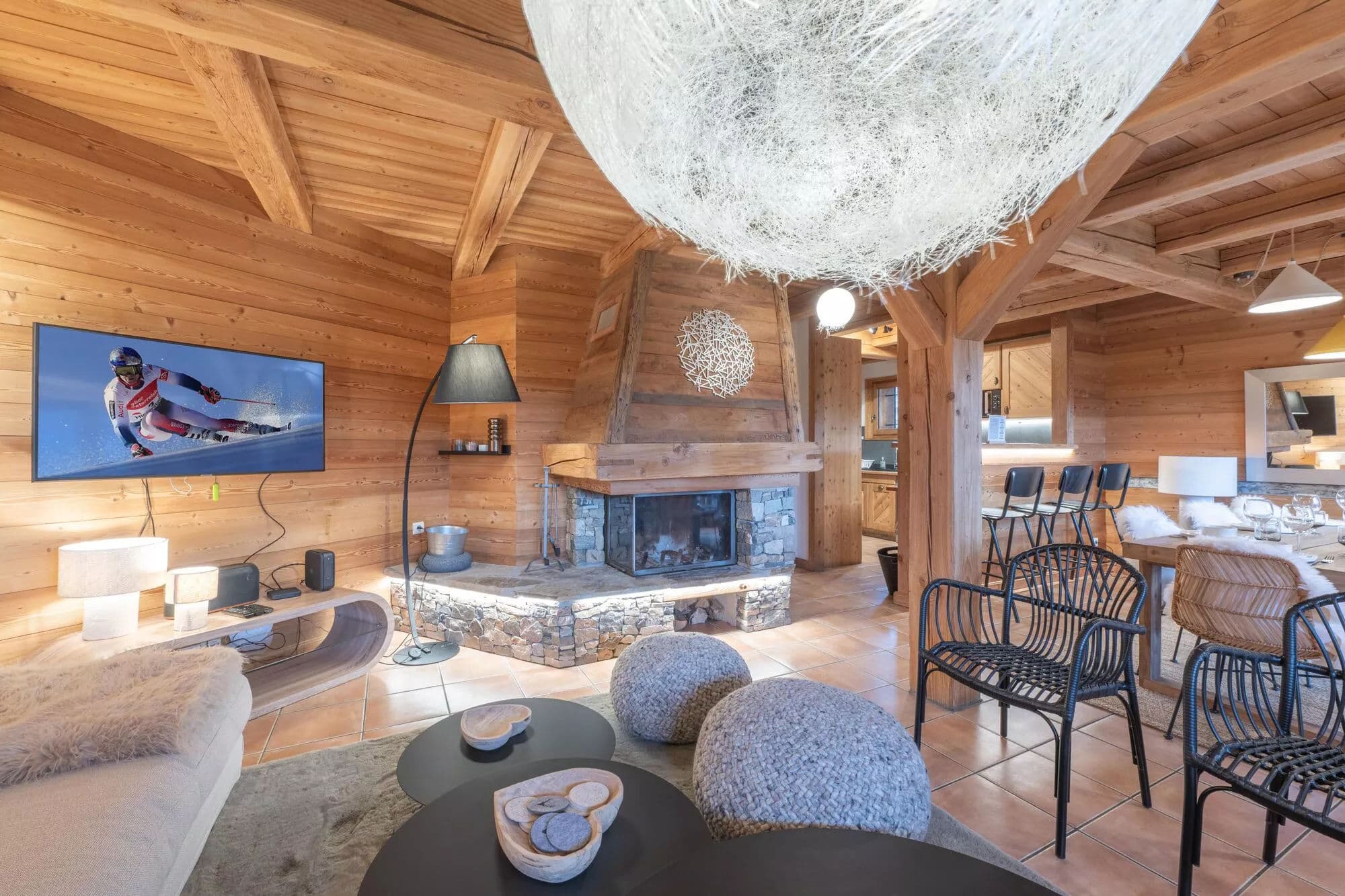Open-plan lounge with fireplace, dining area and timber beams